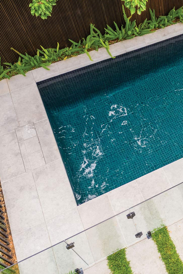 Three HIDE Skimmer Covers in a row beside a blue green tiled pool shown from above