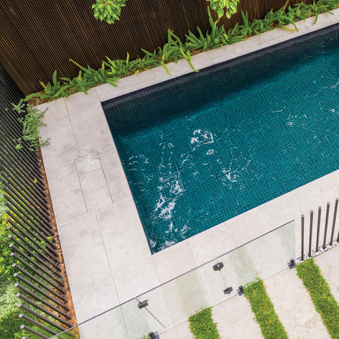 Three HIDE Skimmer Covers in a row beside a blue green tiled pool shown from above