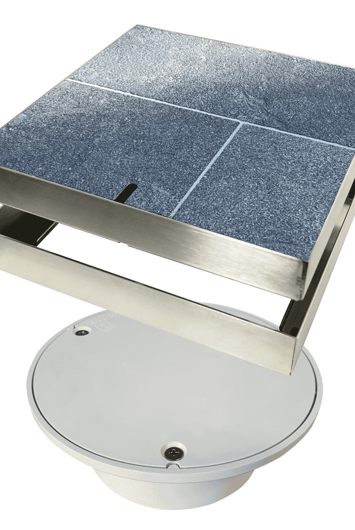 The HIDE Access Cover conceals unsightly plastic service points, such as this Bolted Trap Screw (BTS) cover commonly found in patios and other outdoor areas. It provides a sleek finish while maintaining easy access to this essential service point.