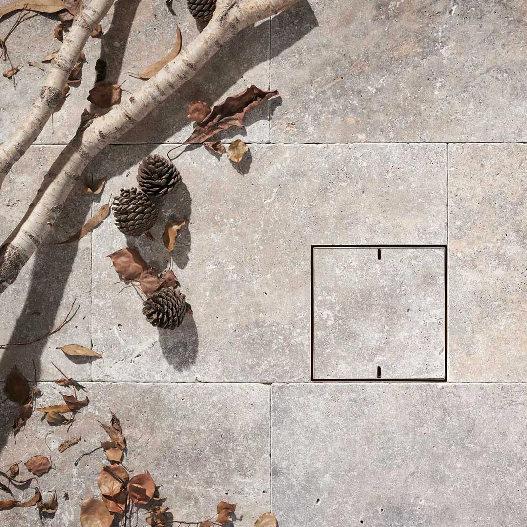 HIDE drain cover with natural stone infill and 2 slots for lifting