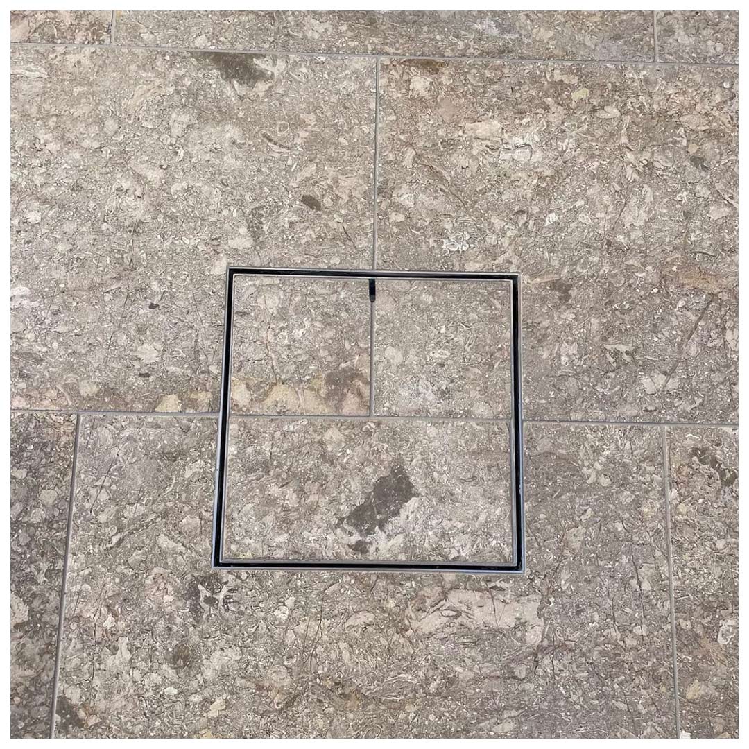 HIDE Drain Cover with brown tile inlay.