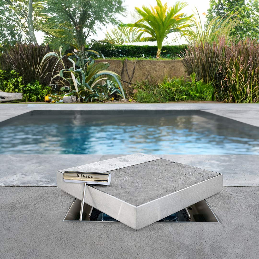 HIDE Skimmer Lid with dual inlay, background has a large pool and tropical landscape.