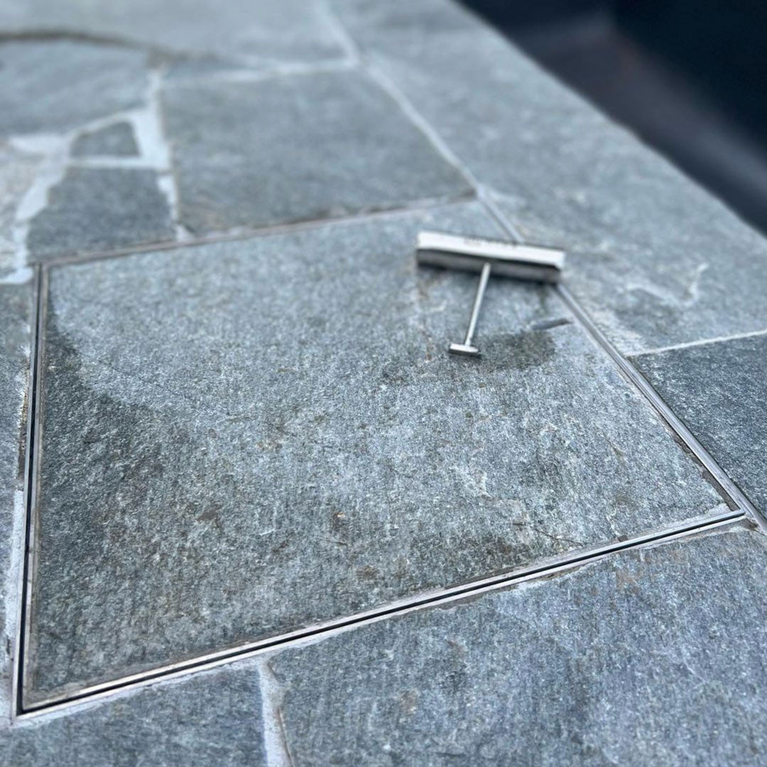 Close up of HIDE Skimmer Lid, Stainless Steel lid and frame with bluestone coloured inlay.