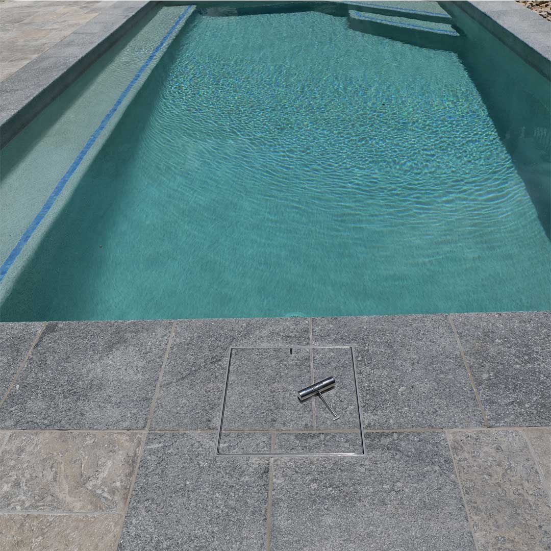 Pool with tiled edge and HIDE Access Cover, grout and tile pattern continuing through the lid