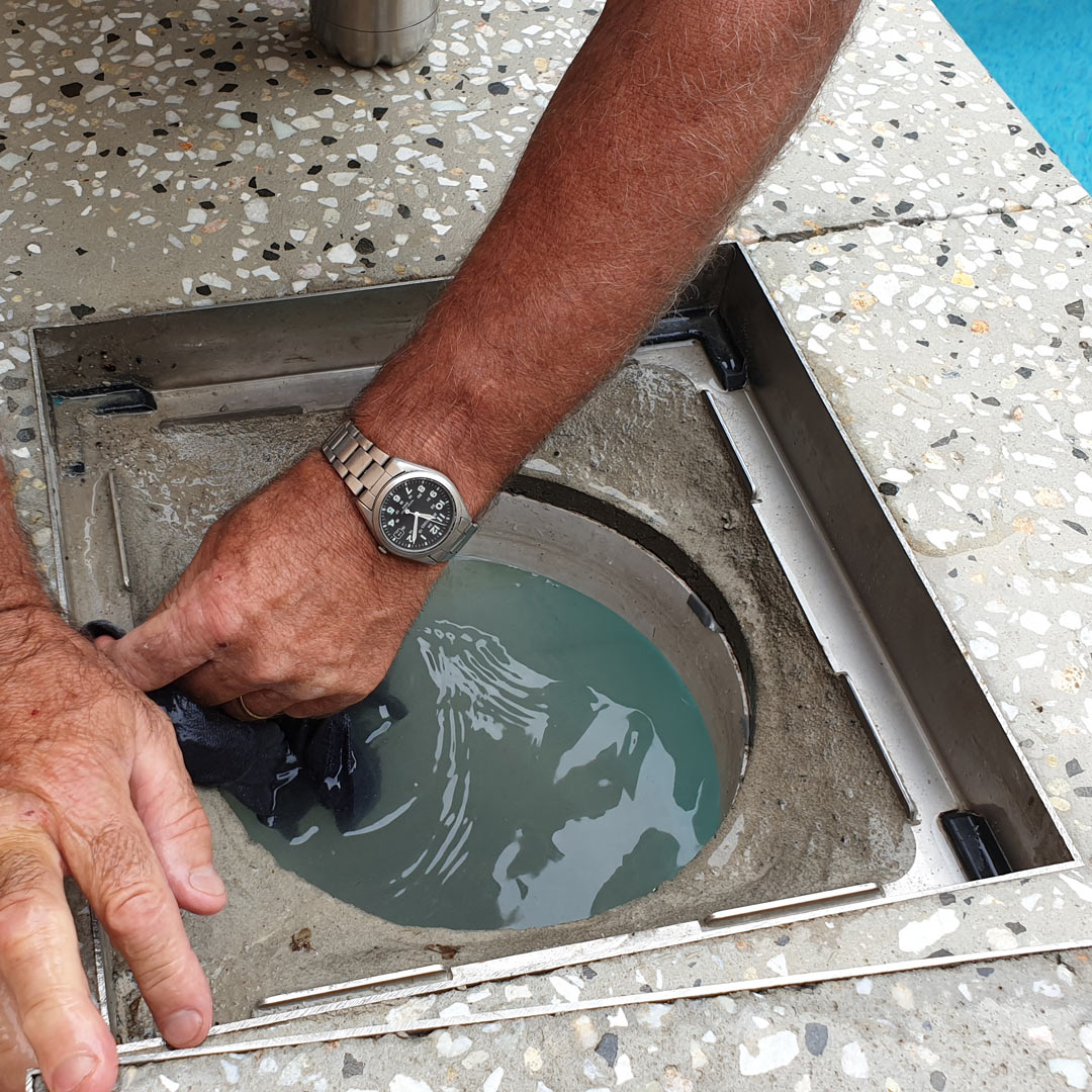 Man can be seen cleaning the HIDE recess frame in accordance to HIDE's warranty & maintenance guidelines.