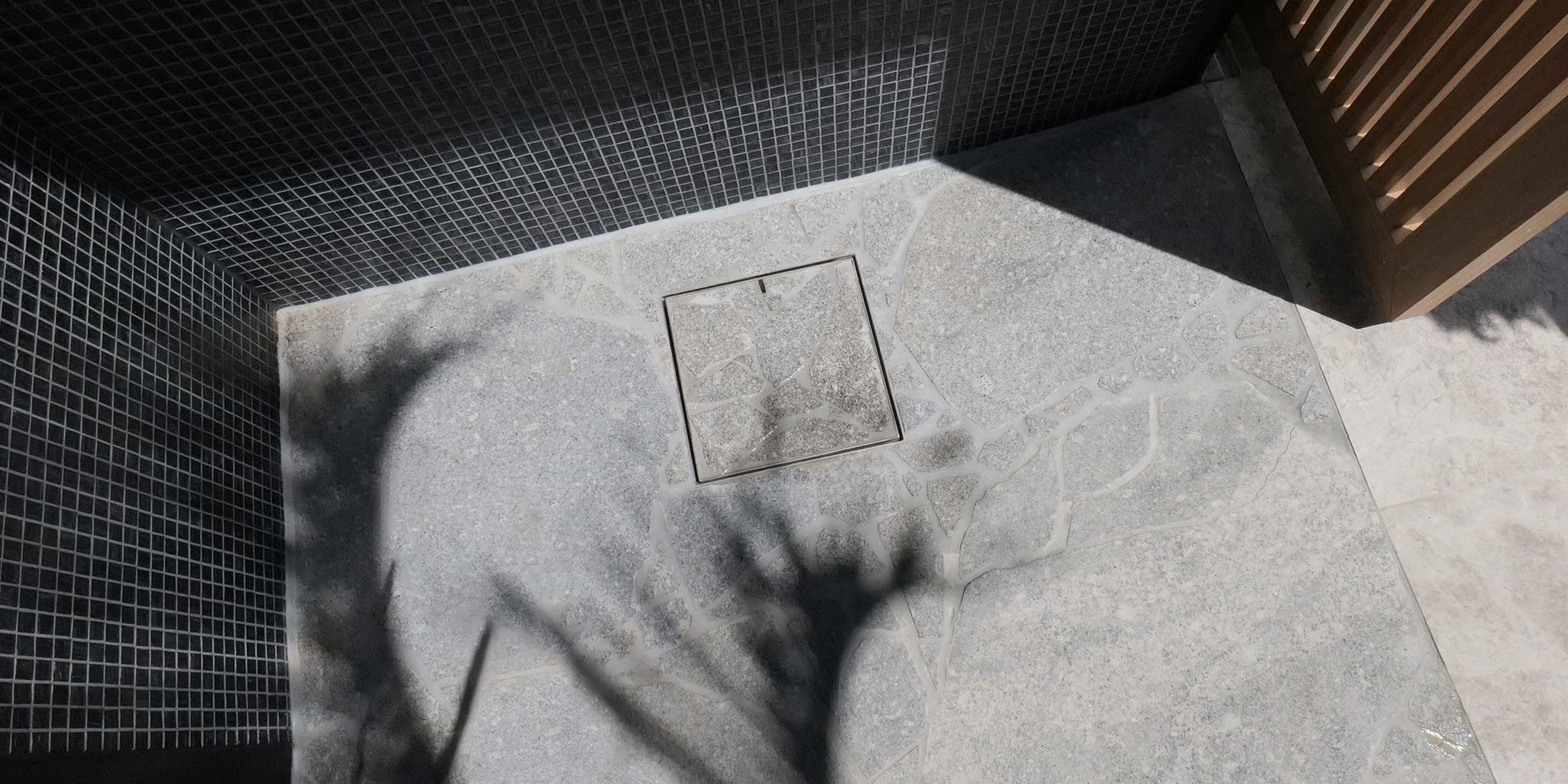 HIDE Drain Cover with grey crazy pave stone installed.