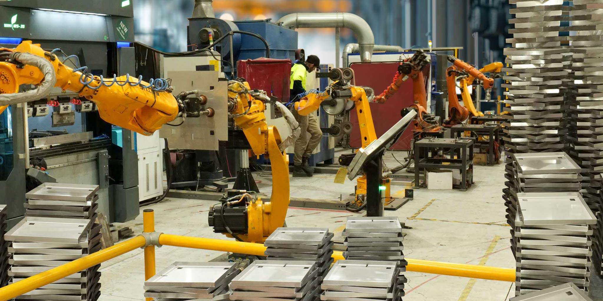 HIDE Robots in the factory making the HIDE lids and frames. Stainless steel lids stacked up showing lots of stock.