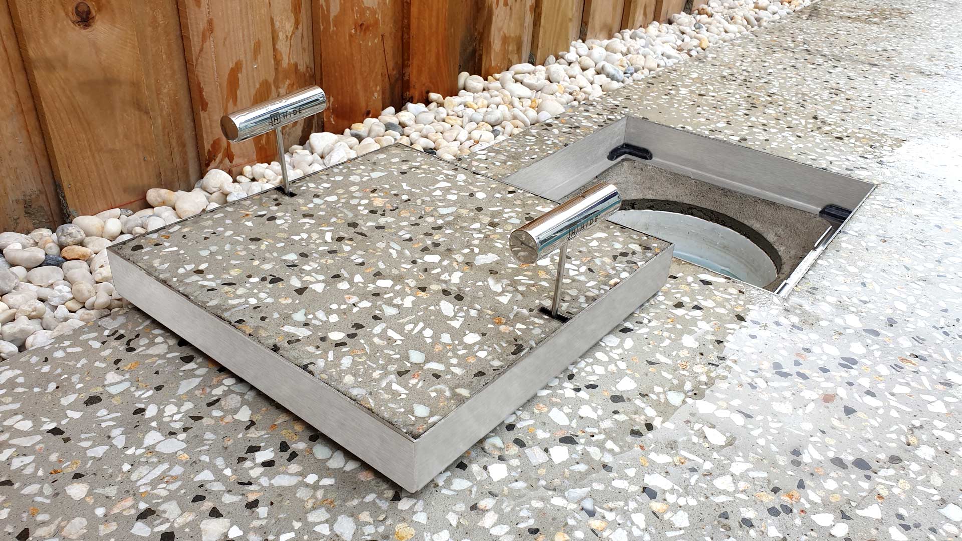 Close up of a HIDE Concrete Skimmer Lid with honed concrete infill.