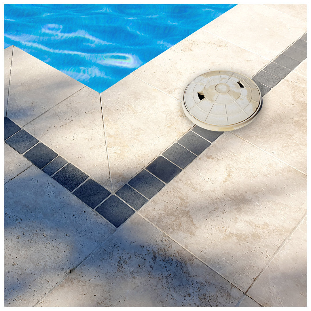 Traditional plastic skimmer lid disrupting the paving pattern.