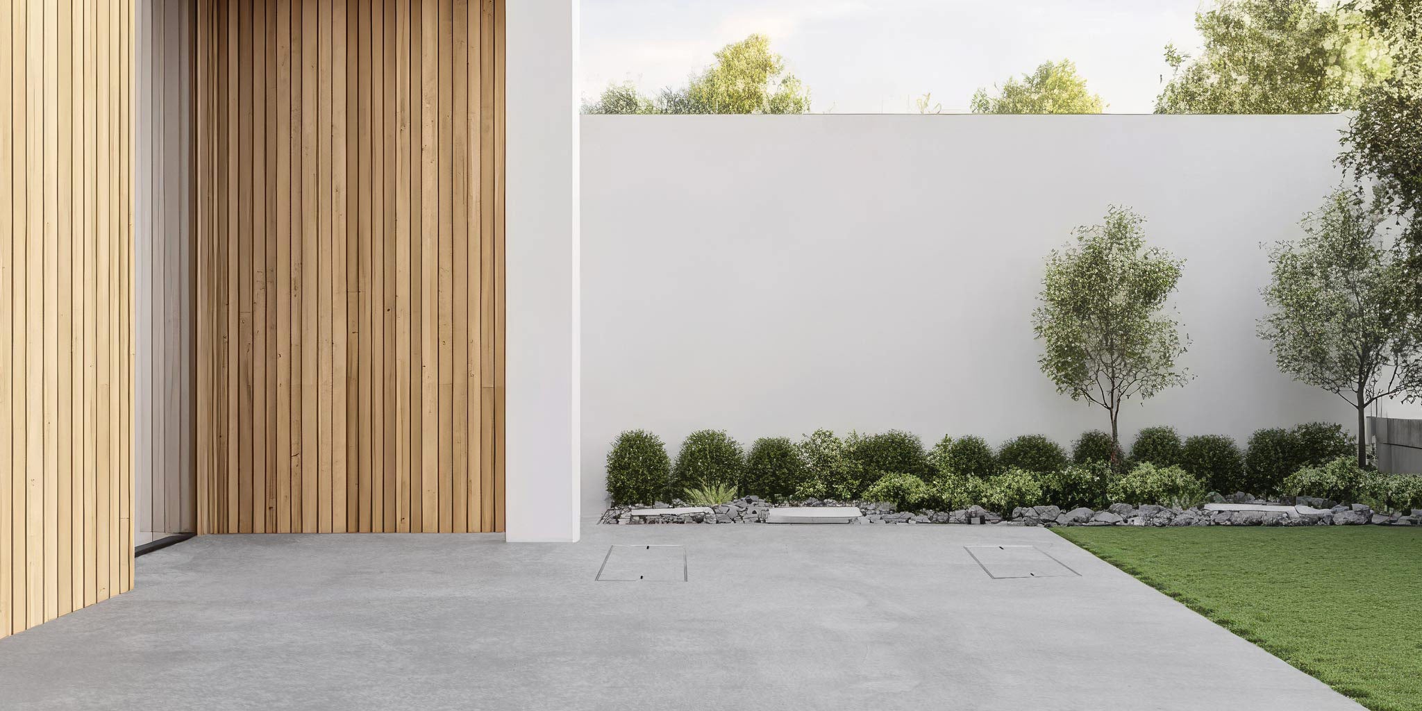 Two HIDE Skimmer Covers installed flush in a concrete patio beside lawn and garden.