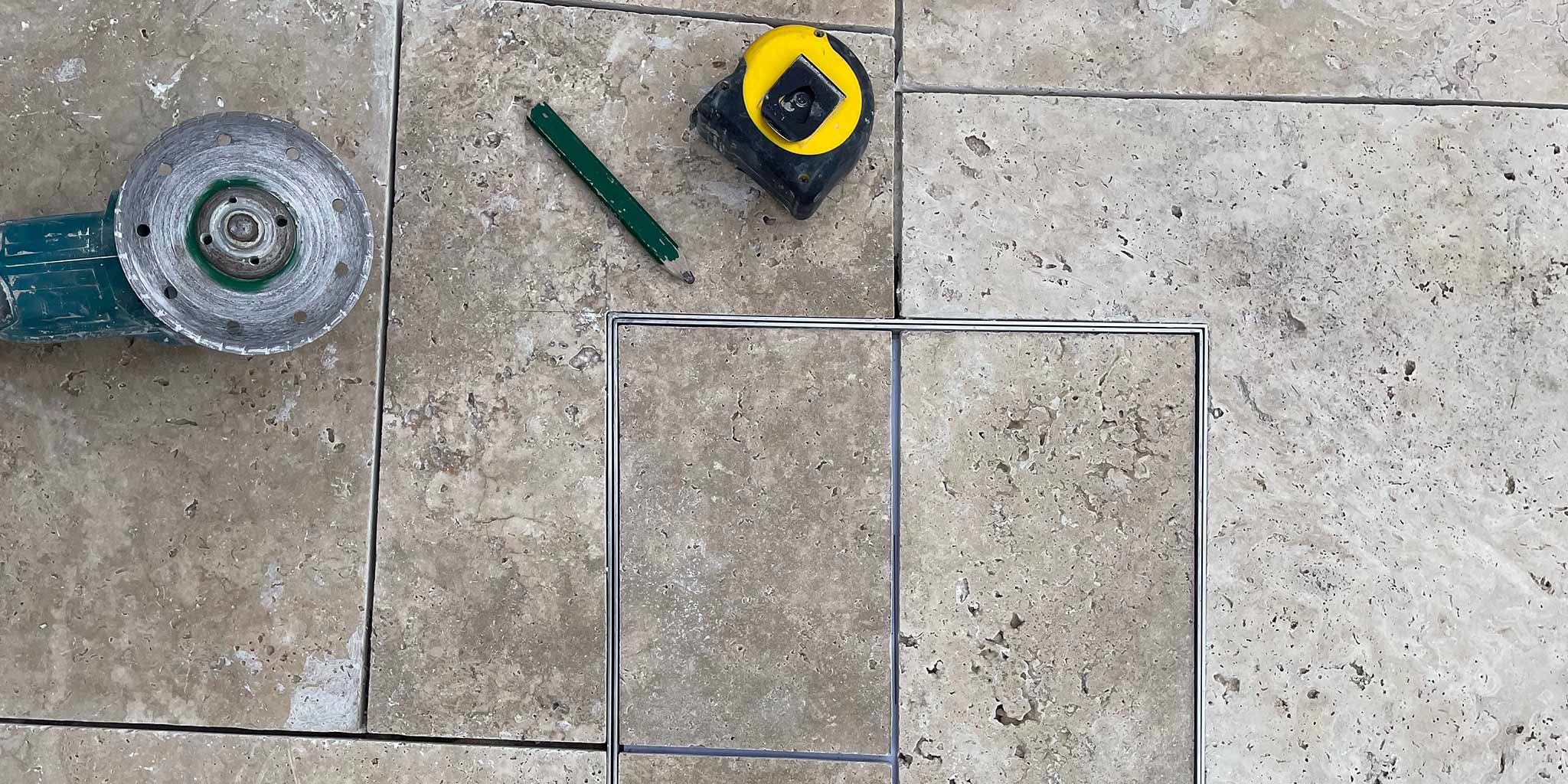 Tile layout marked and cut to fit inside a HIDE stainless steel inlay cover frame.